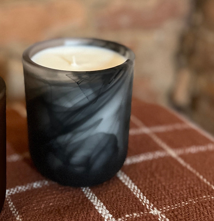 spiral candle on a plaid table with brick background