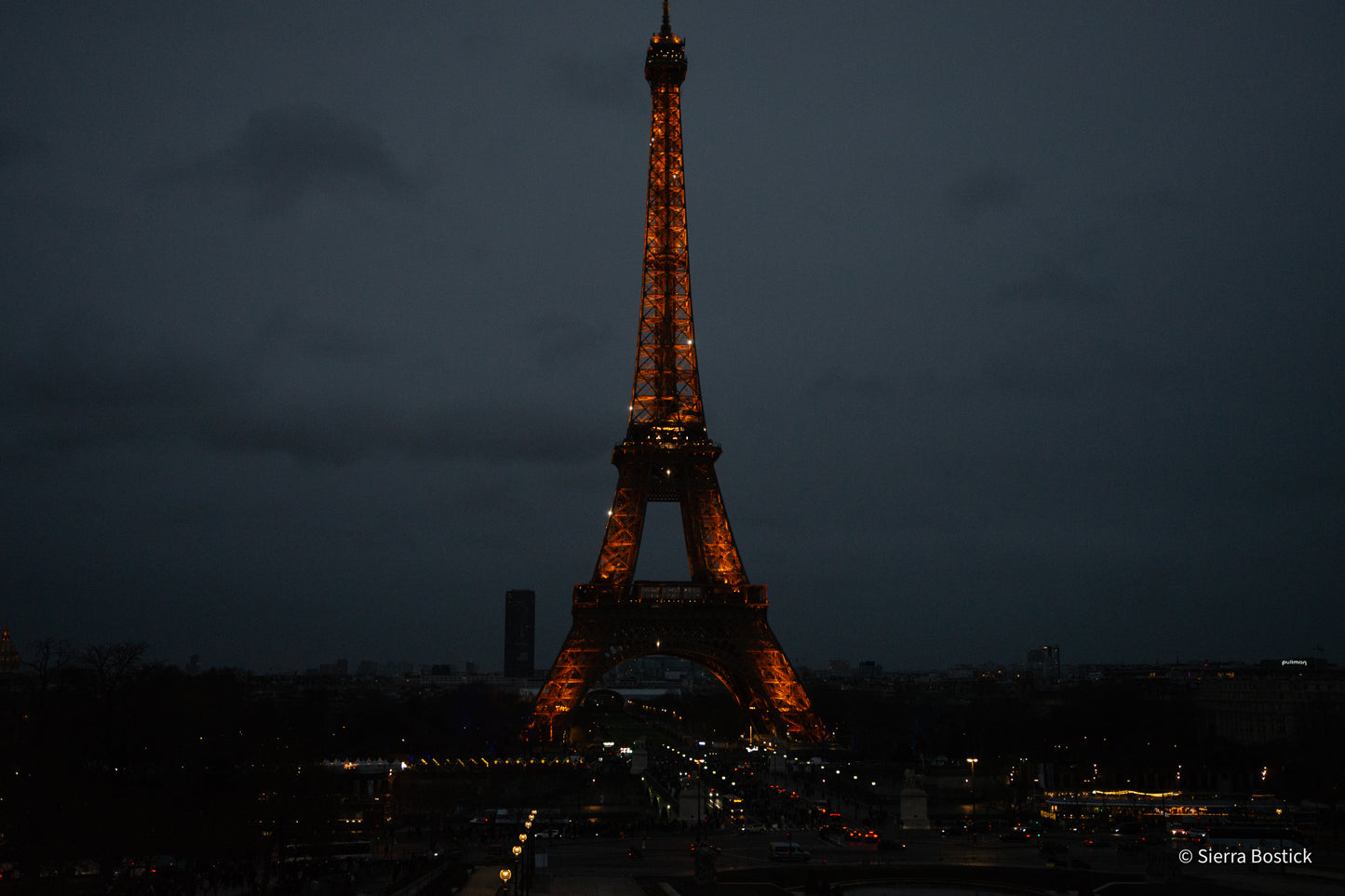 evening photo of the eiffel tower illuminated with city lights
