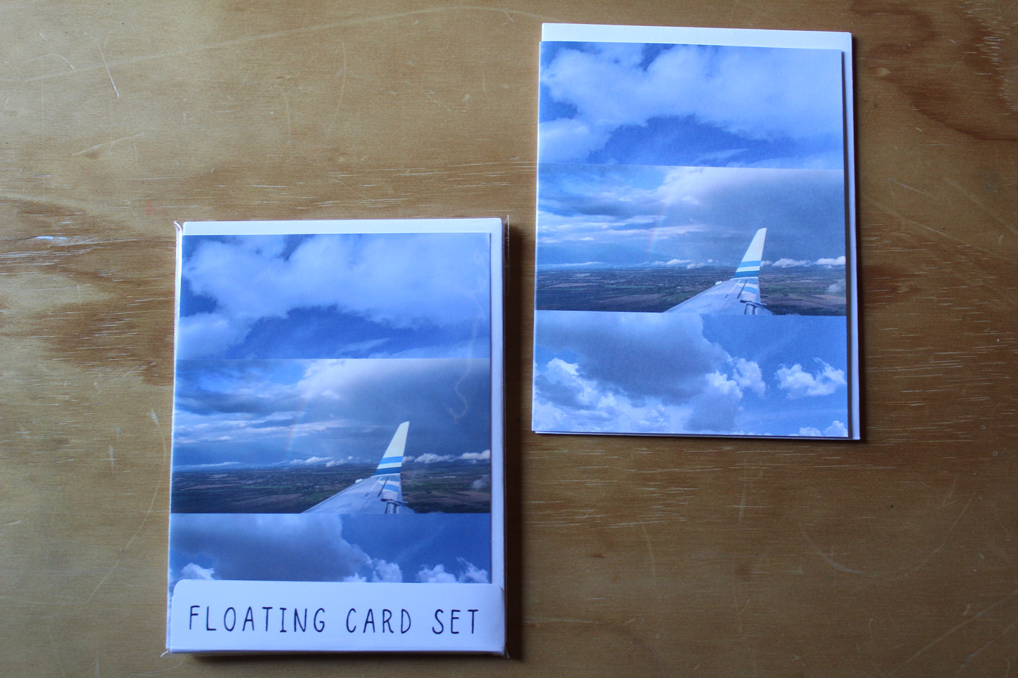 floating card stack with planes and clouds