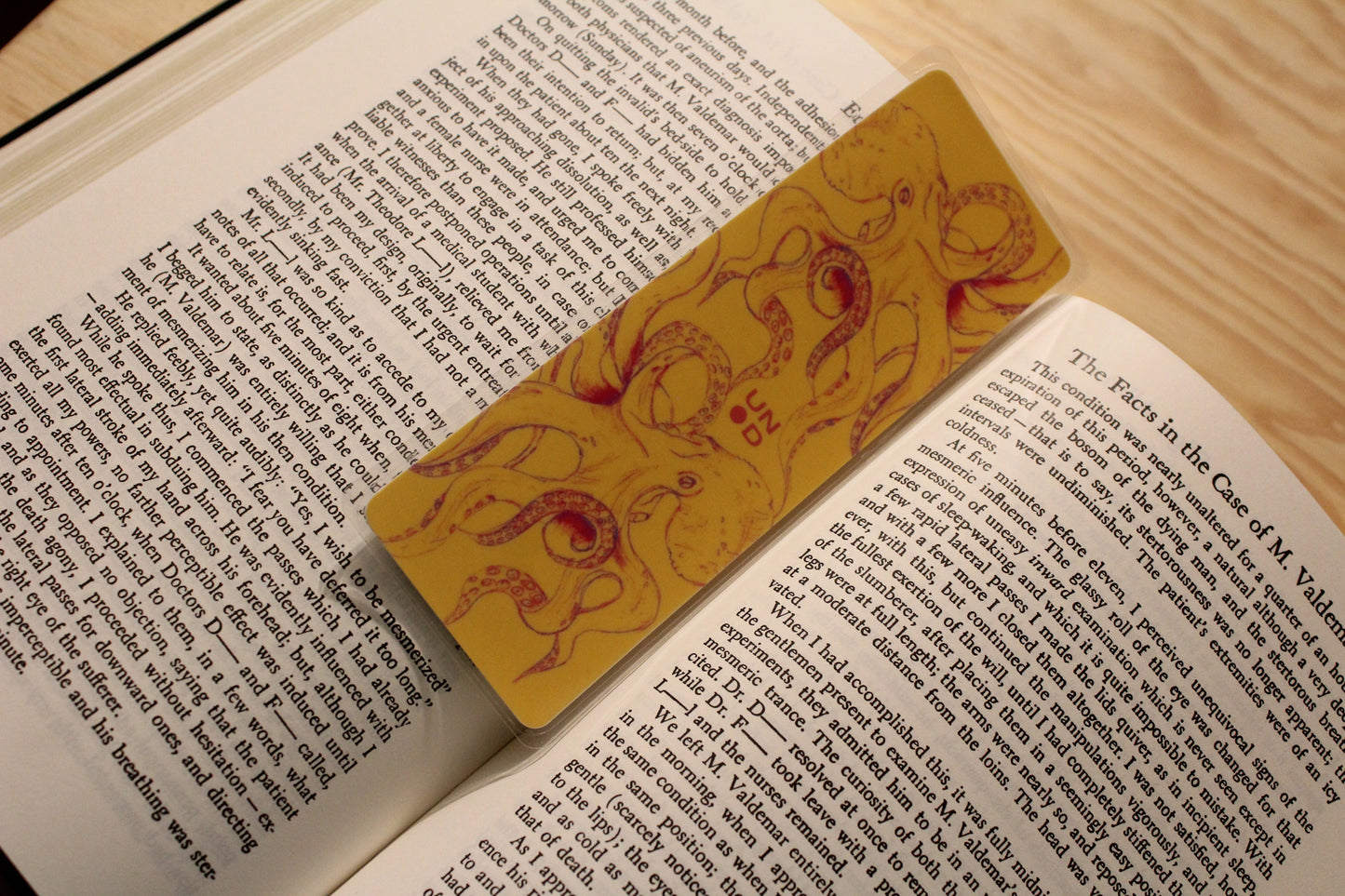Open book with a decorative bookmark on a wooden surface