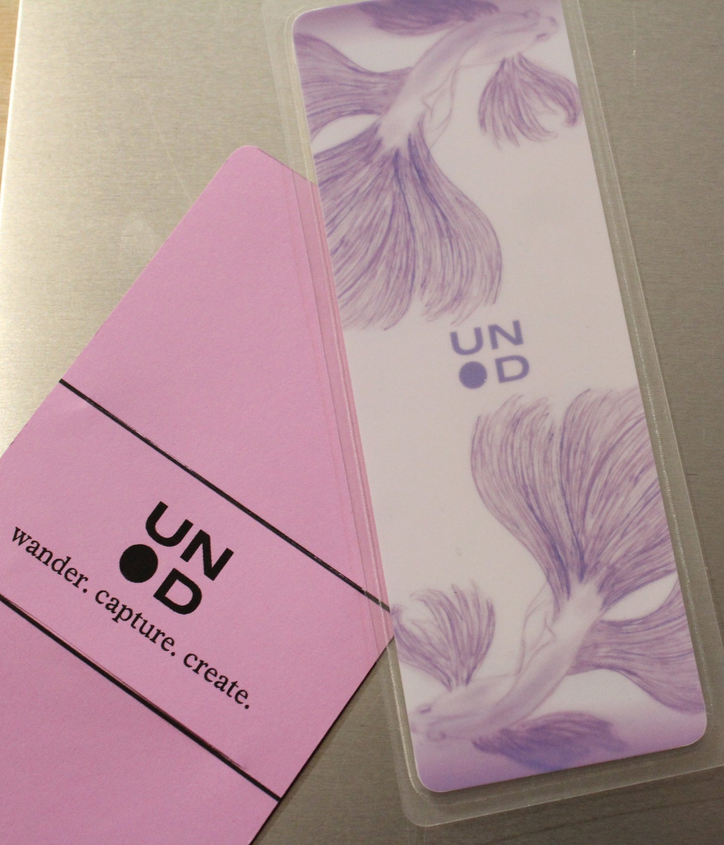 Lavender card with unpunchd branding and beta fish design on a gray surface