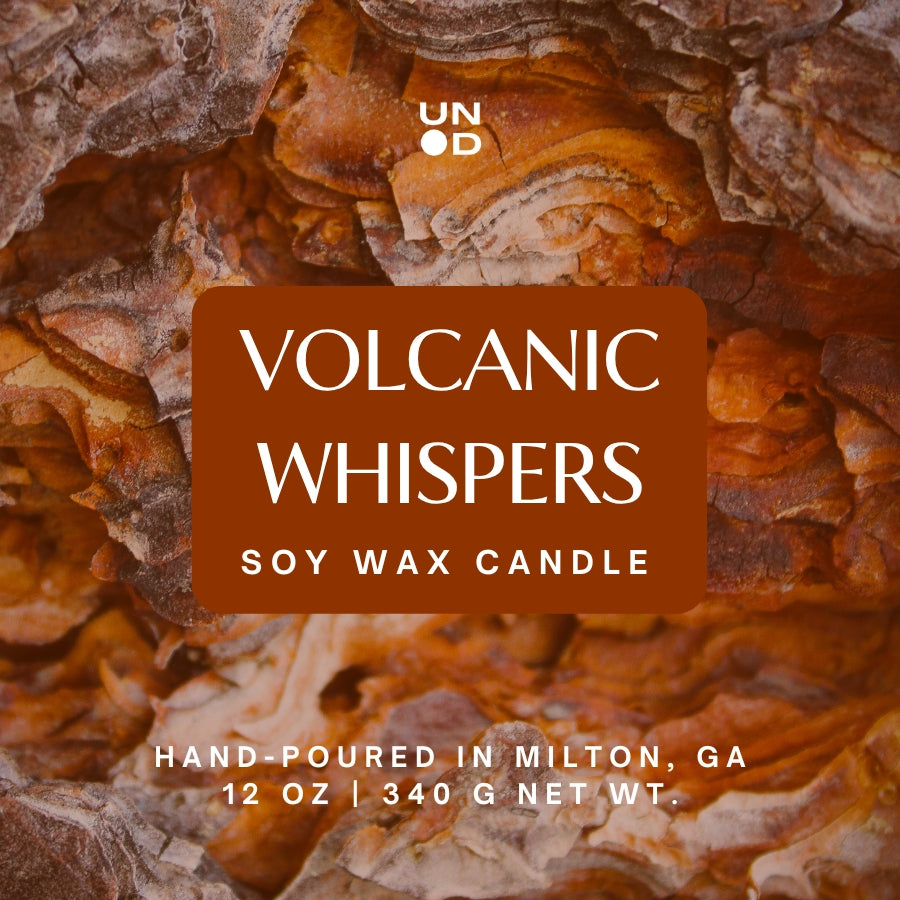 Soy wax candle labeled 'Volcanic Whispers' with a tree bark background.
