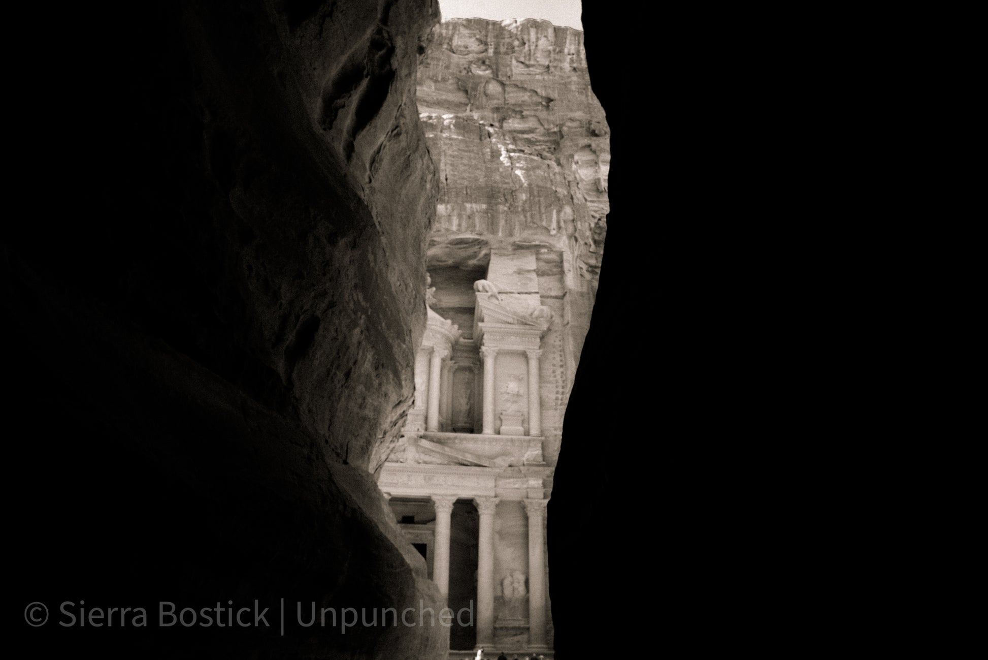 Black and White photo of Petra viewed through Canyon walls.