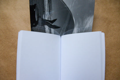 book cover at the top of the page with a depiction of the blank pages of the book