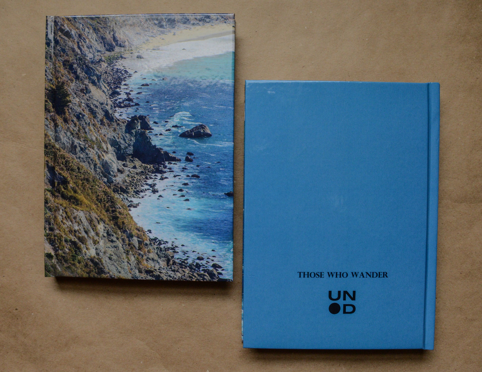 hardcover notebook with big sur coast on the front. back cover is blue with 'Those Who Wander' and the Unpunched logo