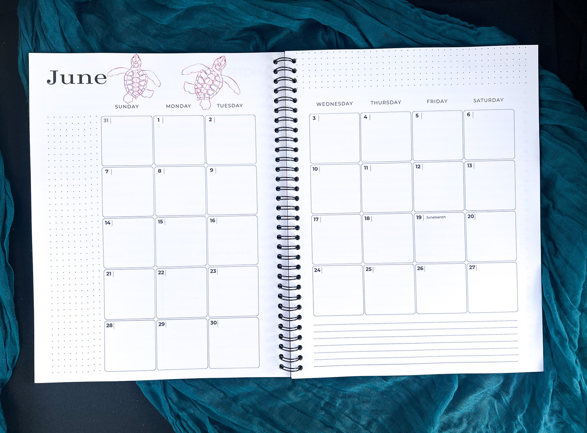 Spiral-bound calendar open to June with turtles on a teal fabric background