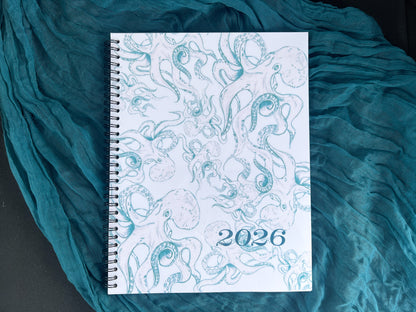 Spiral-bound notebook with 2026 octopus design on a textured teal fabric background