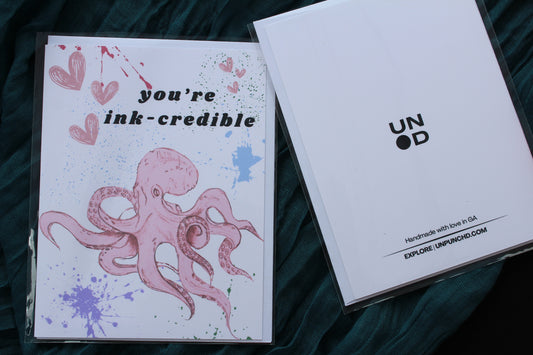 packaged ink-credible card with octopus and paint splatter on the front, back of card view with specs on the back and logo
