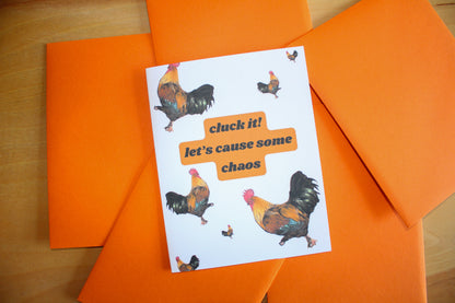 cluck it card with chickens on bright orange envelope background