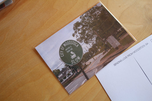 City of woodstock train sign on a postcard
