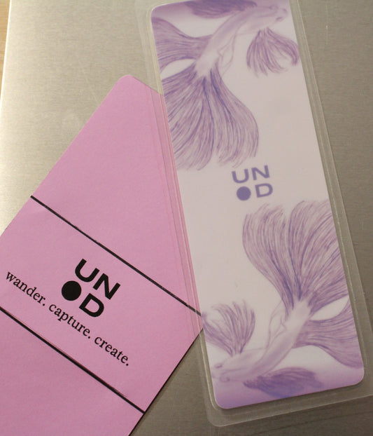 Lavender card with unpunchd branding and beta fish design on a gray surface