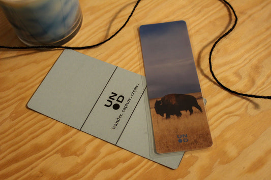 blue bookmark belly with a buffalo design on a wooden surface