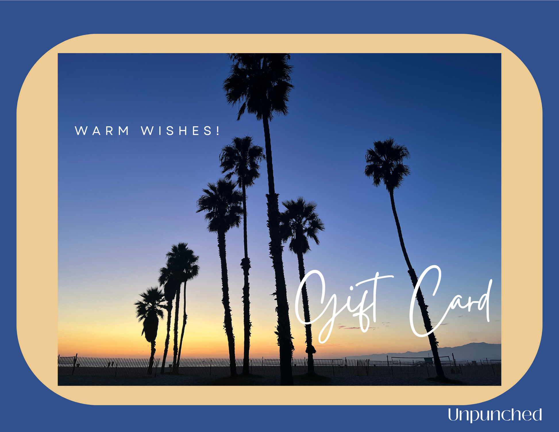 Bright blue rectangle with a sand colored card with a photo of shadowed palm trees against an orange and blue gradient sky in the center. In the top left of the picture reads "Warm Wishes", the bottom right corner of the picture reads "Gift Card". On the rectangle the logo unpunched is in the bottom right corner. Hues of blues and sand colors, with white writing.